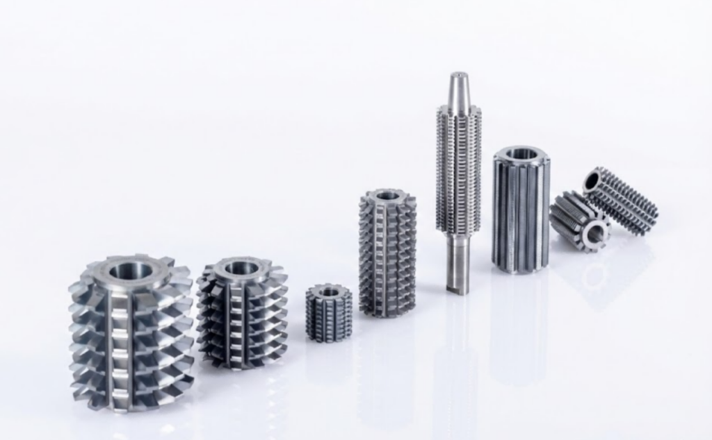 This is a product collection from Nobeve. Nobeve's entire range of gear cutting tool is arranged in a diagonal pattern, with their reflections visible on the tabletop.